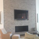 living room wall with tile and tv