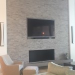 living room wall with tile and tv